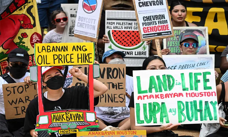 Houston: Demonstrators march against the CERAWeek by S&P Global energy conference on Monday.—AFP Houston: Demonstrators march against the CERAWeek by S&P Global energy conference on Monday.—AFP