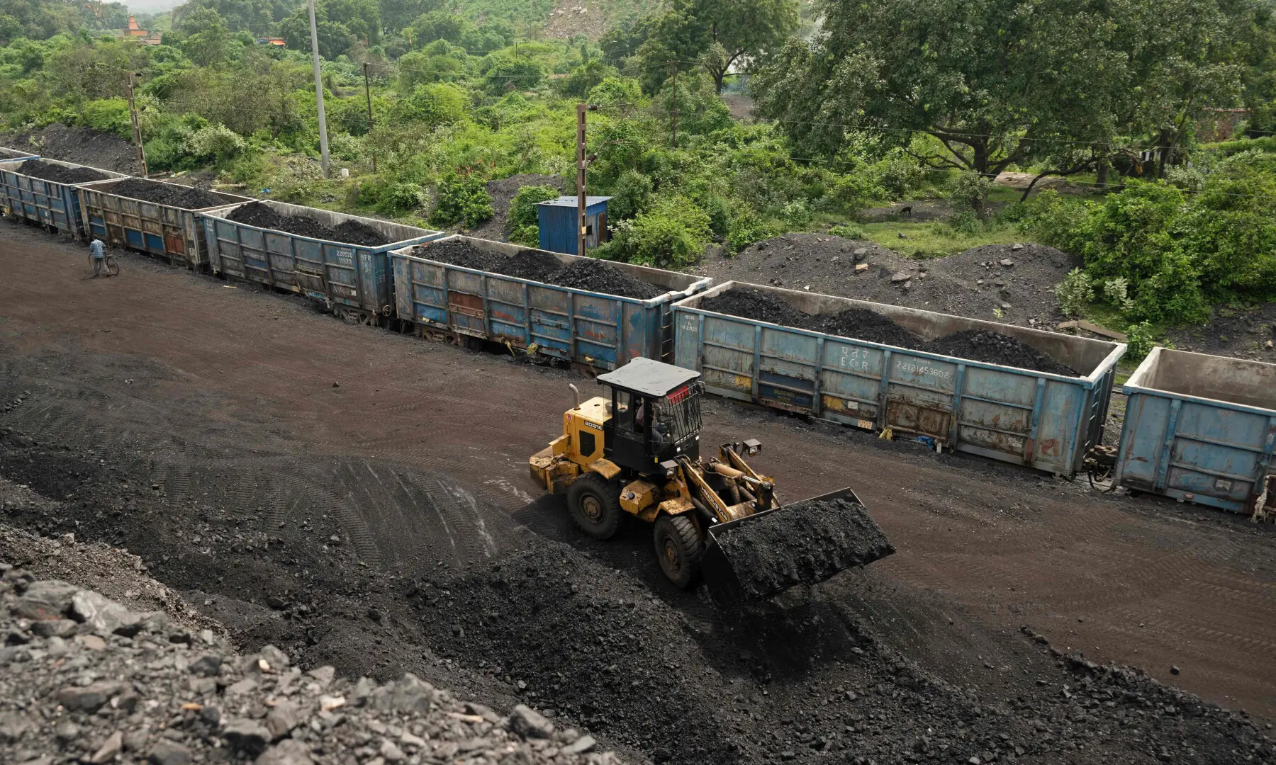 A worker operates a wheel loader to convey heaps of raw coal into train carriages, excavated from an open-cast mine on the outskirts of Dhanbad, in India&rsquo;s Jharkhand state on August 13, 2025. &mdash; AFP/File