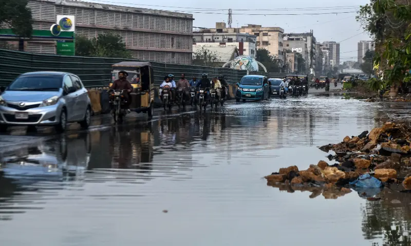 Vehicles travel along a road in Karachi after heavy rain and wind on March 19, 2026. &mdash; White Star/File