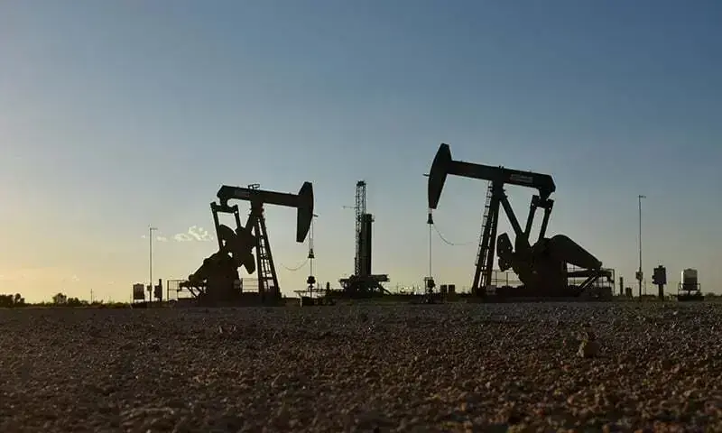 This file photo shows pump jacks operating in front of a drilling rig in an oil field. Photo for representation only. — Reuters/File This file photo shows pump jacks operating in front of a drilling rig in an oil field. Photo for representation only. — Reuters/File