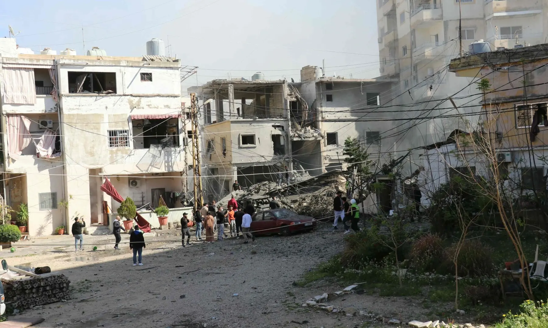 Residents gather at the site of an Israeli airstrike that targeted the southern Lebanese coastal city of Tyre on March 24. &mdash; AFP