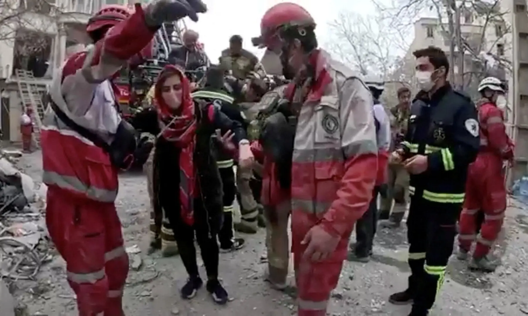 A woman is helped by Iranian Red Crescent personnel following a reported strike, amid the US-Israeli war on Iran, in Tehran, Iran, in this screengrab from video released on March 23. &mdash; Reuters