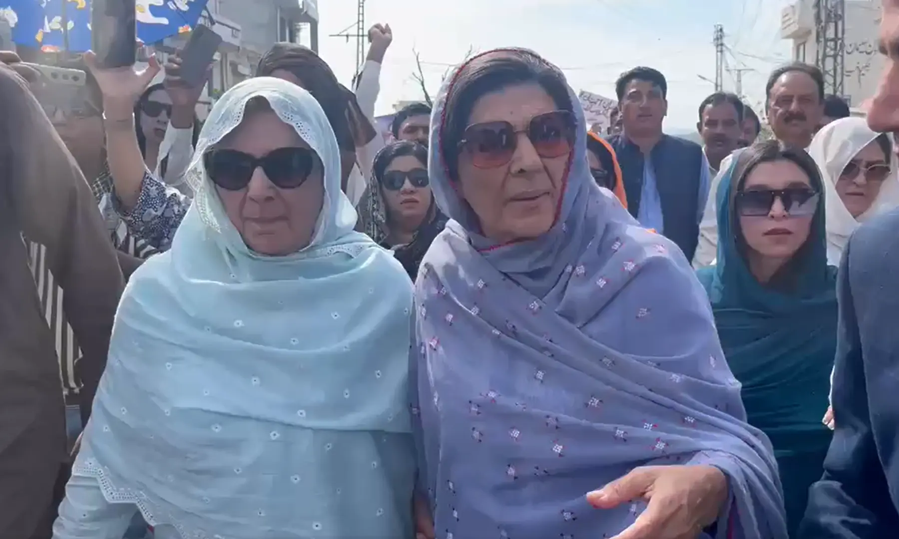 PTI founder Imran Khan&rsquo;s sister, Aleema Khanum and Noreen Niazi, walk toward Rawalpindi&rsquo;s Adiala jail on March 24. &mdash; Screengrab via PTI/X