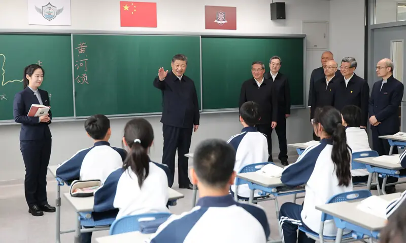 PRESIDENT Xi Jinping speaks with students at a school during an inspection tour of Xiongan New Area.&mdash;Reuters