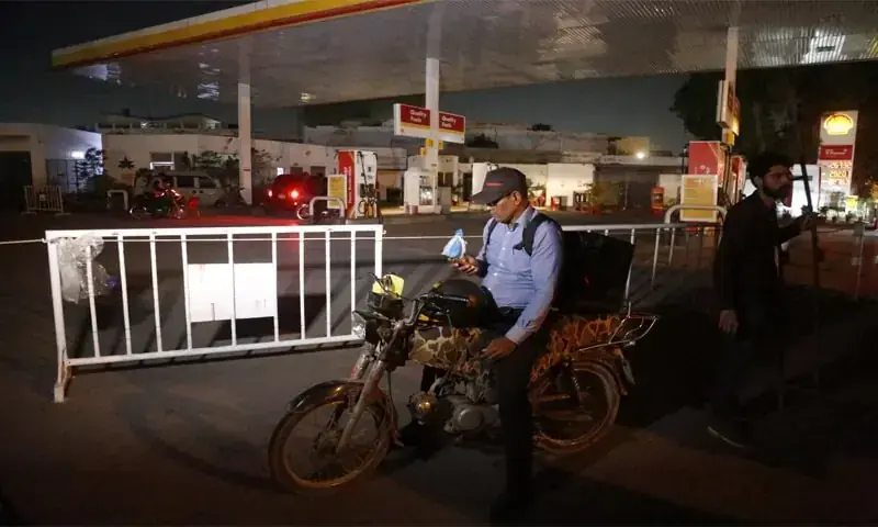 A MOTORCYCLIST looking for fuel stands outside a closed petrol pump in Karachi.&mdash;Shakil Adil / White Star