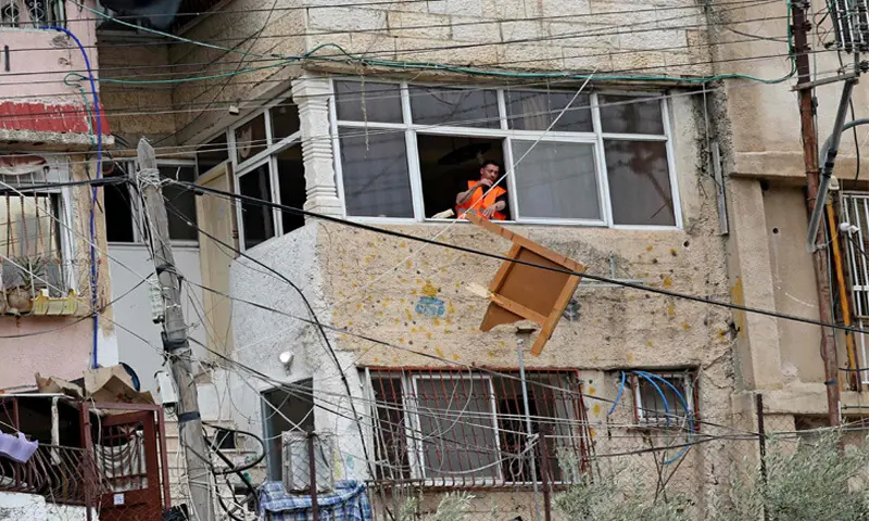 Israeli authorities throw belongings from the window of a Palestinian home in Batan al-Hawa area of occupied east Jerusalem.—AFP Israeli authorities throw belongings from the window of a Palestinian home in Batan al-Hawa area of occupied east Jerusalem.—AFP