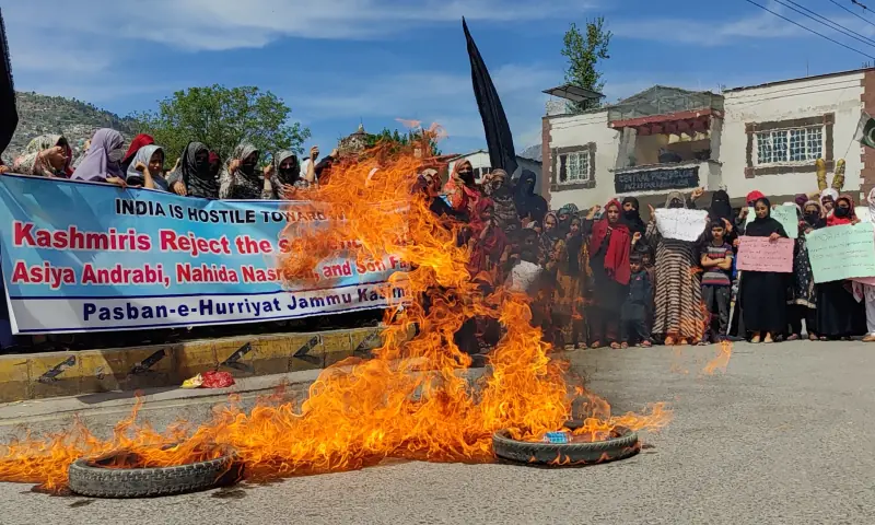 Women burn tyres at a demonstration against the sentencing of three Kashmiri women activists to prison in India, in Muzaffarabad on March 25. &mdash; via Tariq Naqash