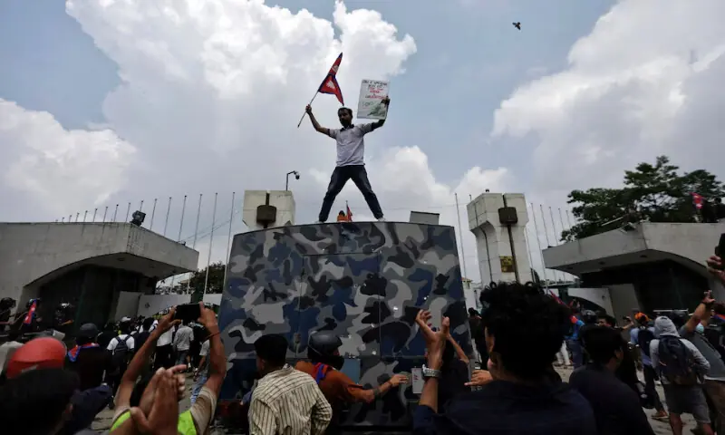 A demonstrator waves a flag as he stands atop a vehicle near the entrance of the Parliament during a protest against corruption and government’s decision to block several social media platforms, in Kathmandu, Nepal September 8, 2025. — Reuters A demonstrator waves a flag as he stands atop a vehicle near the entrance of the Parliament during a protest against corruption and government’s decision to block several social media platforms, in Kathmandu, Nepal September 8, 2025. — Reuters