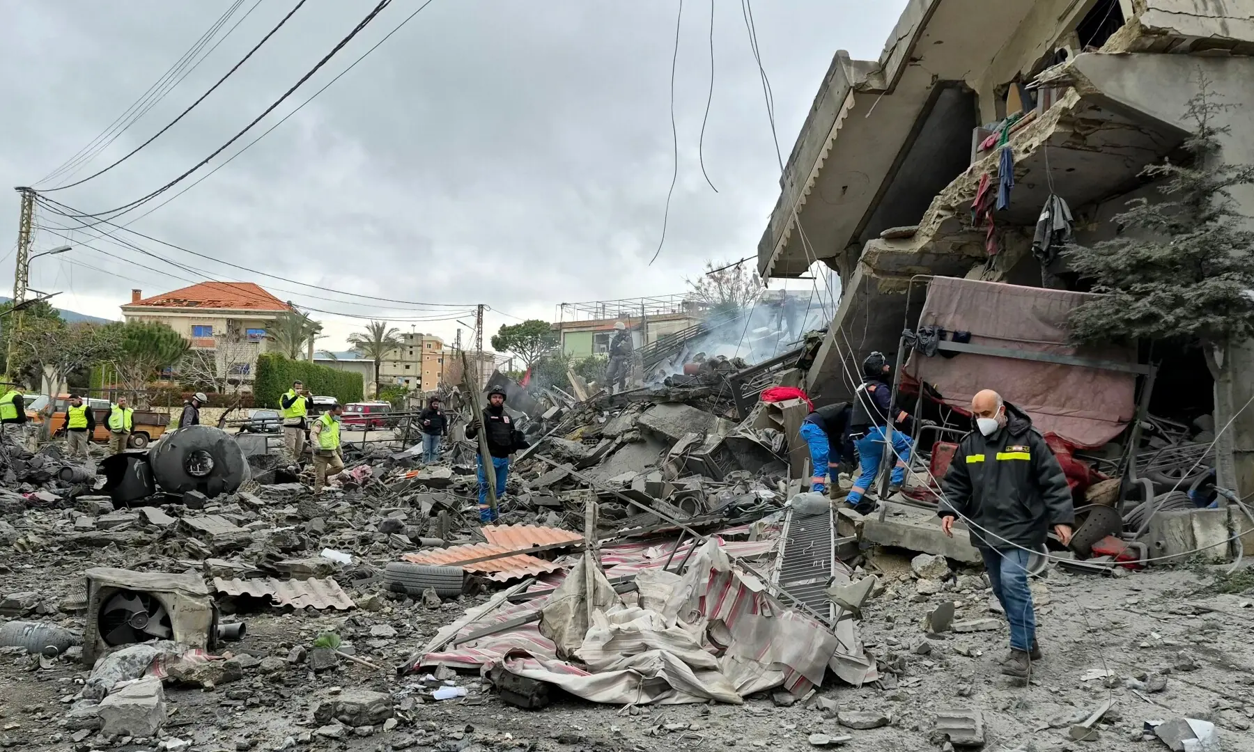 First aid responders are seen at the site of an Israeli airstrike that targeted the southern Lebanese village of Kfar Roummane on March 26. &mdash; AFP
