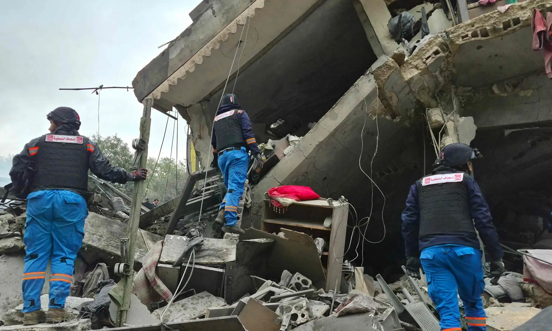 First aid responders are seen at the site of an Israeli airstrike that targeted the southern Lebanese village of Kfar Roummane on March 26. &mdash; AFP
