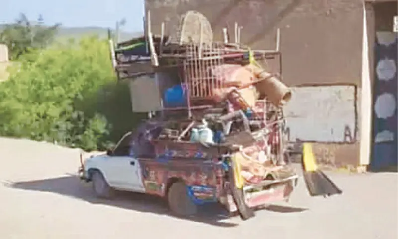 A vehicle carrying the belongings of a family leaves a village in Shewa tehsil. — Dawn A vehicle carrying the belongings of a family leaves a village in Shewa tehsil. — Dawn