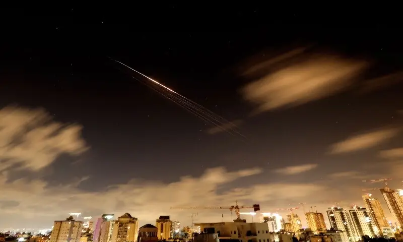 Rocket trails are seen in the sky amid a fresh barrage of Iranian missile attacks above the Israeli coastal city of Netanya on March 27, 2026. &mdash;AFP