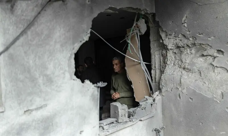 A resident surveys the damage to a house following a projectile strike in the Arab-Israeli city of Kfar Qassem on March 26, 2026. &mdash;AFP