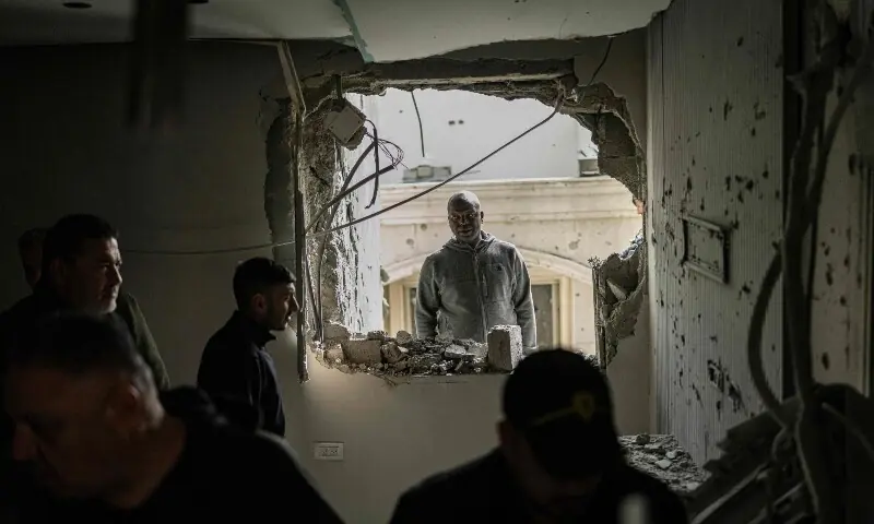 Residents surveys the damage to a house following a projectile strike in the Arab-Israeli city of Kfar Qassem on March 26, 2026. &mdash;AFP