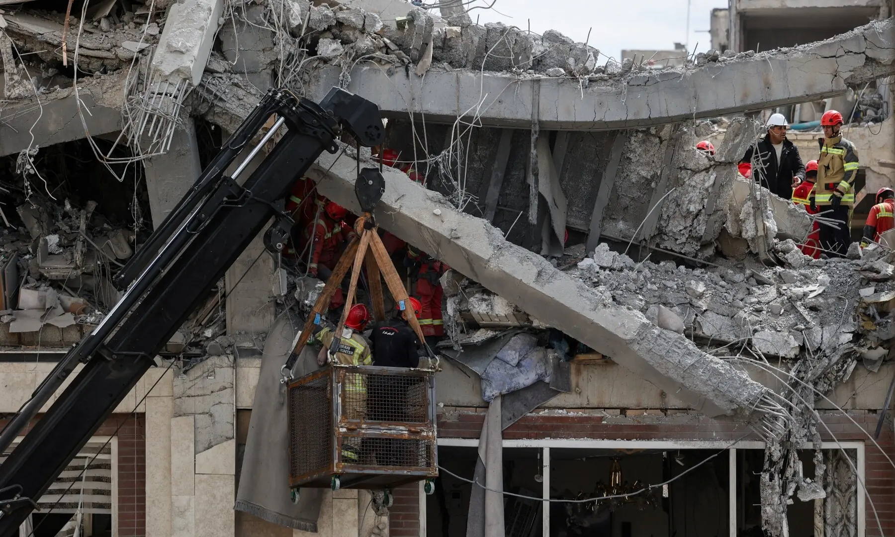 Emergency responders remove a casualty from beneath the rubble at a site of a residential building damaged by a strike, amid the US-Israeli conflict with Iran, in Tehran, Iran on March 27, 2026. — Reuters