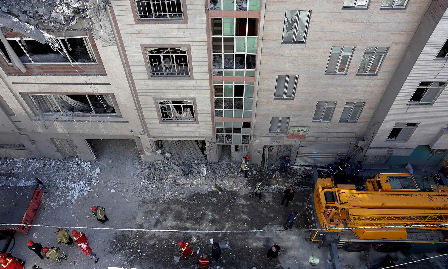 Firefighters look for victims and inspect damages at a residential building in southern Tehran, Iran on March 27. &mdash; AFP