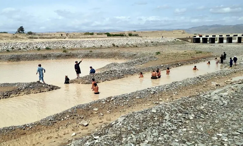 QUETTA: Children play in rainwater accumulated in an area on the outskirts of the provincial capital.—PPI QUETTA: Children play in rainwater accumulated in an area on the outskirts of the provincial capital.—PPI