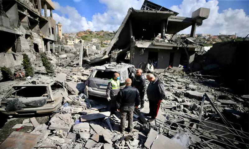 FIRST aid responders inspect the site of an Israeli air strike that targeted a building in the southern Lebanese town of Saksakiyeh.—AFP FIRST aid responders inspect the site of an Israeli air strike that targeted a building in the southern Lebanese town of Saksakiyeh.—AFP