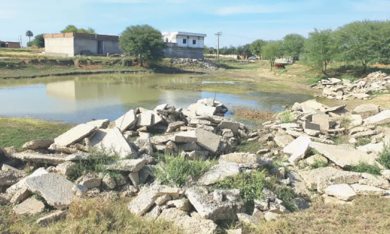 A contractor dumps debris on the bank of a pond in Mohrah Jaswal along Gujar Khan Road. — Dawn A contractor dumps debris on the bank of a pond in Mohrah Jaswal along Gujar Khan Road. — Dawn