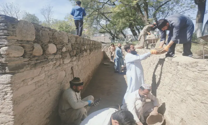 Archeologists busy in excavation work at Butkara I site in Swat. &mdash; Dawn