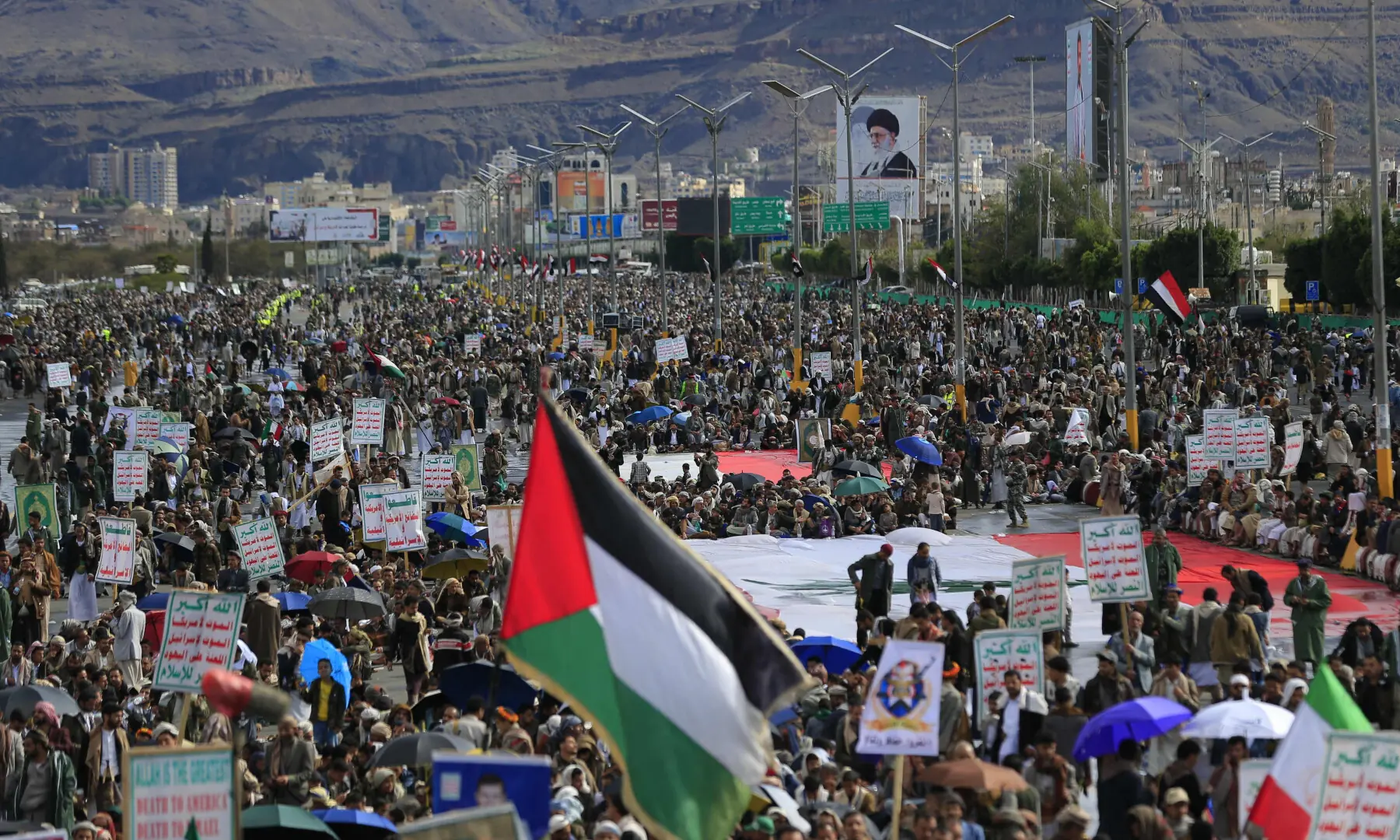 A Palestinian flag is raised as Houthis rally in solidarity with Iran and Lebanon, in the Yemeni capital Sanaa on March 27, 2026. &mdash; AFP