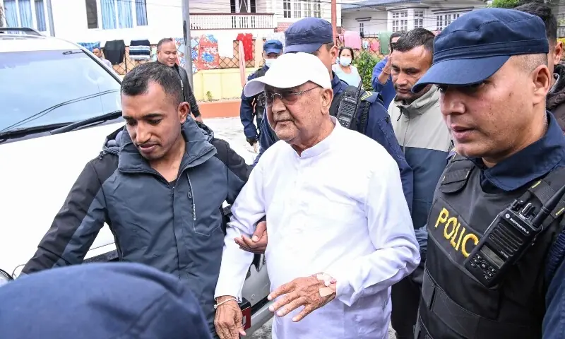 Nepal&rsquo;s former prime minister K P Sharma Oli (C) is escorted by police as he is brought to the hospital following his arrest in Kathmandu on March 28, 2026. &mdash; AFP