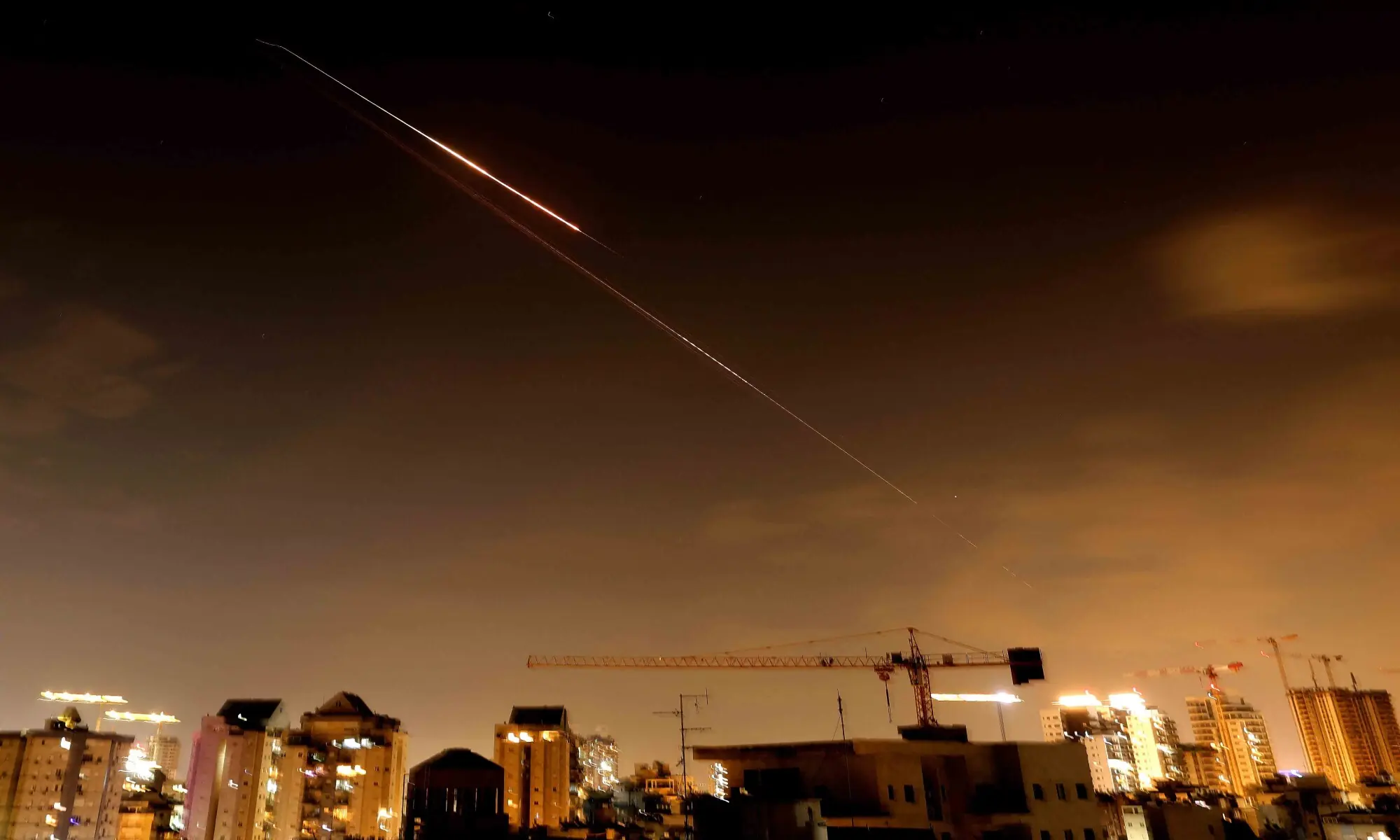 Rocket trails are seen in the sky above the Israeli coastal city of Netanya amid a fresh barrage of Iranian missile attacks late on March 27, 2026. &mdash; AFP