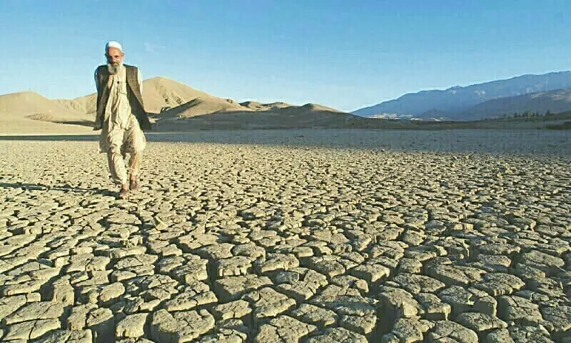 A man walks on the dried, cracked landscape near Hanna Lake, Quetta. &mdash;AFP/File