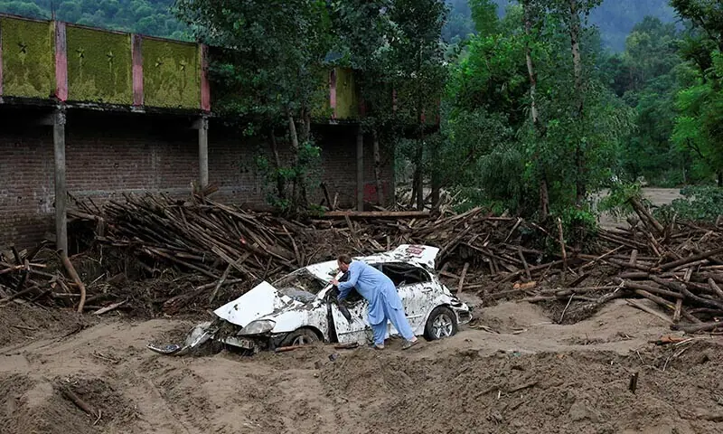 Gul Rasheed, 60, inspects a damaged car following a storm that caused heavy rains and flooding, in Bayshonai Kalay, Buner district, Khyber Pakhtunkhwa on August 17, 2025 &mdash; Reuters/File