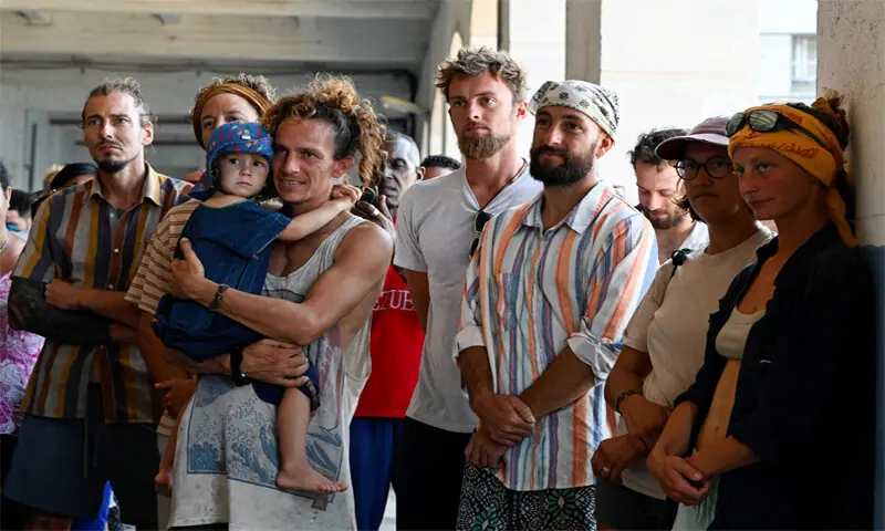 Havana: Activists from the Nuestra America Convoy stand in Havana Bay after their sailboats were located by the Mexican Navy. The sailboats went missing while carrying humanitarian aid from Mexico to Cuba.&mdash;Reuters