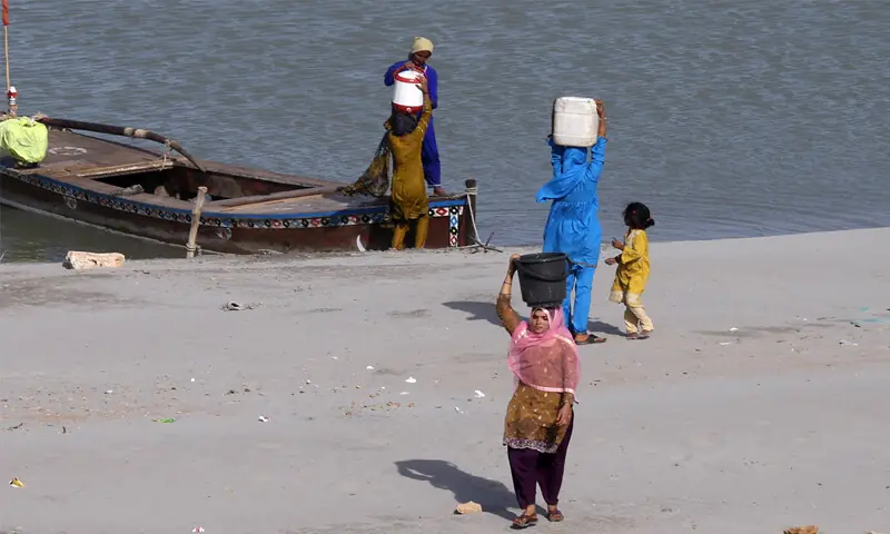 JAMSHORO:Girls return to their village after collecting water from the Indus River.&mdash;APP