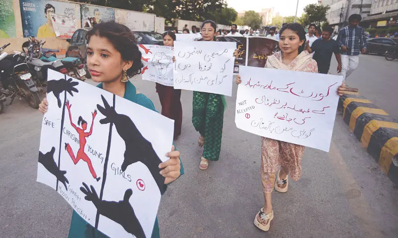 A Christian girl leads a rally demanding effective implementation of laws against forced conversion and child marriages.—PPI A Christian girl leads a rally demanding effective implementation of laws against forced conversion and child marriages.—PPI