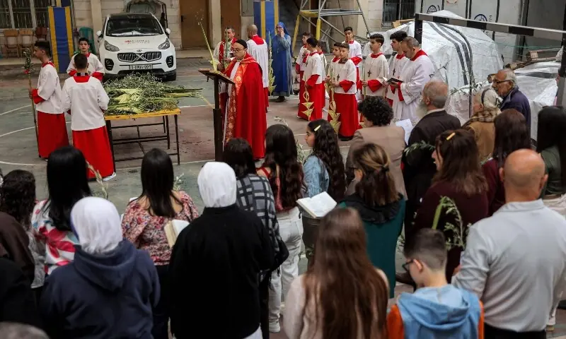 Father Gabriel Romanelli, parish priest at the Roman Catholic Church of the Holy Family, leads the Palm Sunday service at the church in Gaza City on March 29, 2026. —AFP