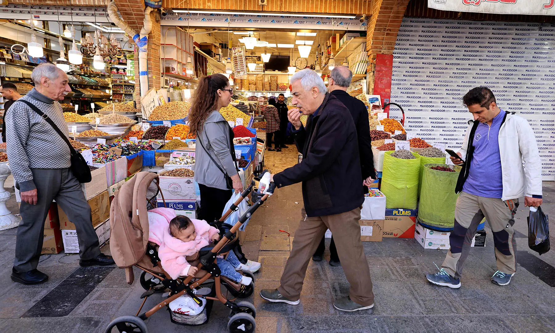 People walk past shops at the Grand Bazaar in Tehran, Iran on March 30 &mdash; AFP