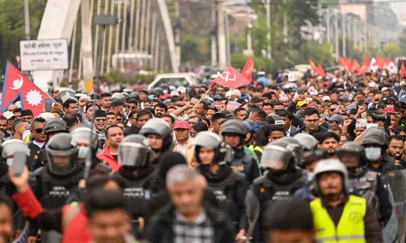 SUPPORTERS of Nepal’s former prime minister Sharma Oli march during a protest against his arrest.—AFP SUPPORTERS of Nepal’s former prime minister Sharma Oli march during a protest against his arrest.—AFP
