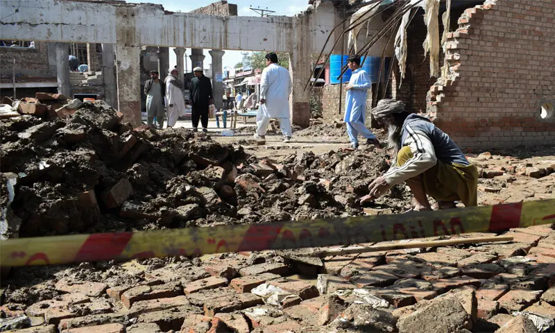 A man clears the rubble of his house which collapsed during heavy rains
in Bannu.—Reuters A man clears the rubble of his house which collapsed during heavy rains
in Bannu.—Reuters