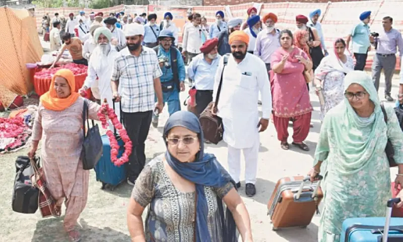 Sikh pilgrims from India enter Pakistan via Wagah Border. — White Star / M. Arif/File Sikh pilgrims from India enter Pakistan via Wagah Border. — White Star / M. Arif/File