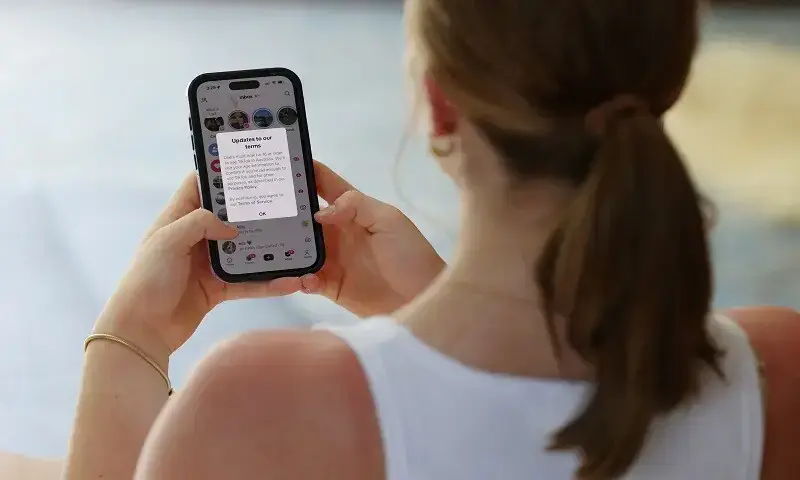 Stella Pieterse, 14, poses holding a mobile phone displaying a message from TikTok as law banning social media for users under 16 in Australia takes effect, in Sydney, Australia, on Dec10, 2025. &mdash; Reuters/File