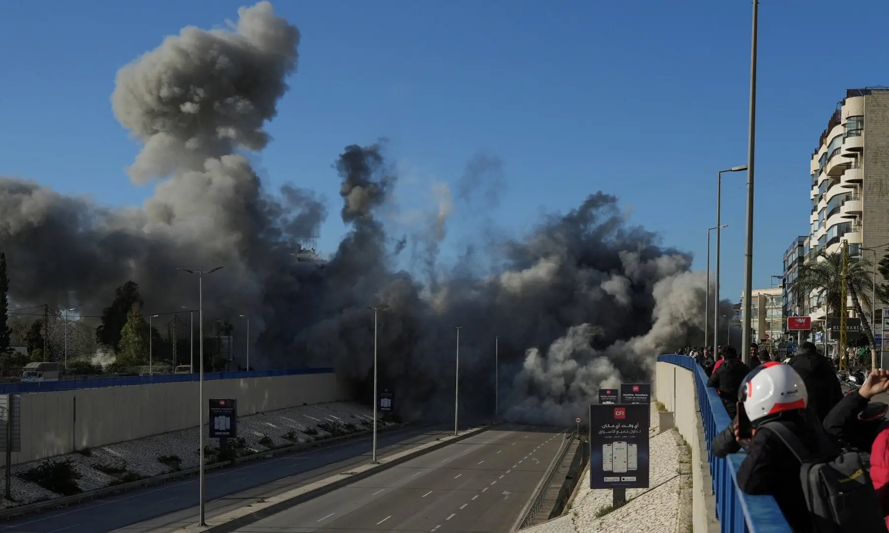 People look at a damaged building following an Israeli strike, amid escalating hostilities between Israel and Hezbollah, in Beirut, Lebanon on March 31. &mdash; Reuters