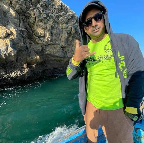 Akif on a boat headed to a hunting expedition