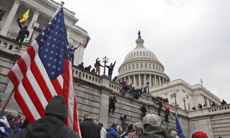 Supporters of President Trump scale the walls of the Capitol Building on January 6, 2021 | Reuters