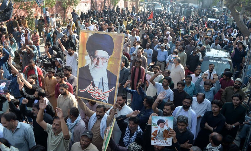 PROTESTERS pass through a street in Hyderabad on Sunday.&mdash;Dawn