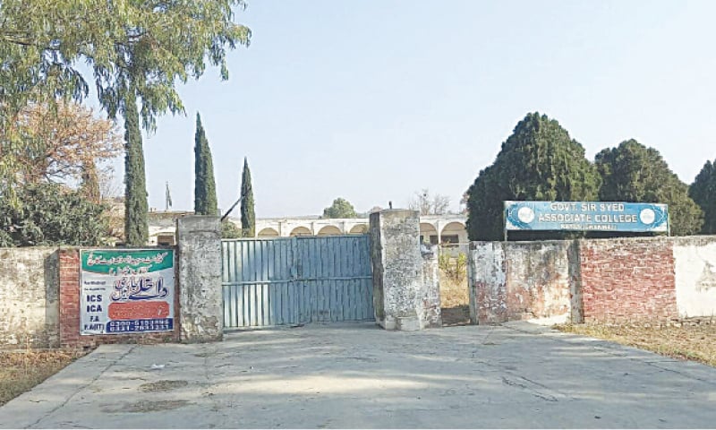 The main gate of Govt Sir Syed Associate College Katas where a banner vainly announces admissions for different intermediate programmes. The main gate of Govt Sir Syed Associate College Katas where a banner vainly announces admissions for different intermediate programmes.