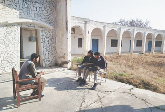 A college teacher internee, Mohammad Taiyab, teaches two students (twin brothers) of first year.