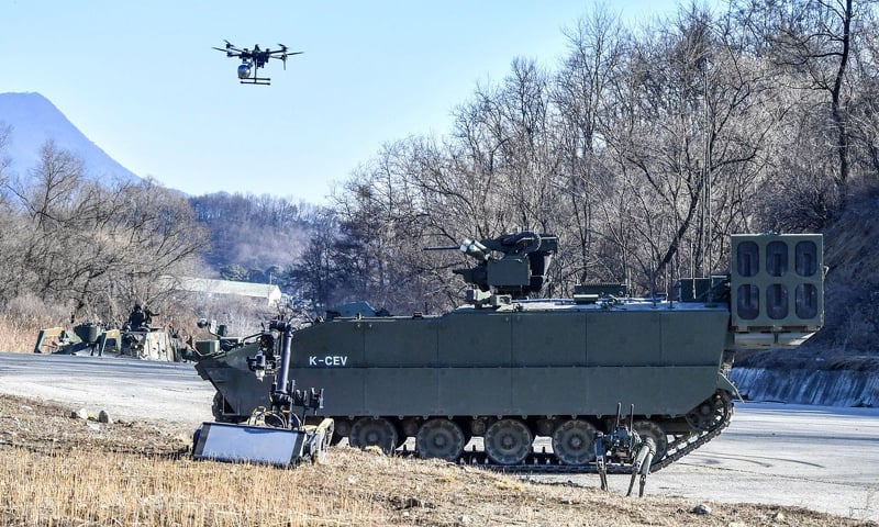 A Korean Combat Engineer Vehicle approaches an obstacle zone as an onboard reconnaissance drone surveys nearby terrain.&mdash;Courtesy The Korea Herald
