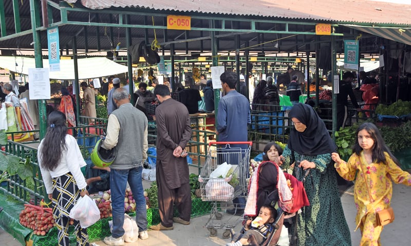 ISLAMABAD: People buy greens in cashless Ramazan Sahulat Bazaar.&mdash;Online