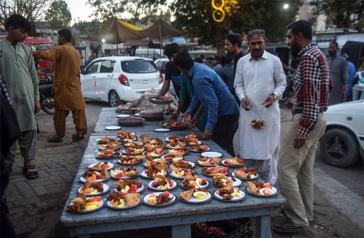 An iftar table being laid out by volunteers. —Fahim Siddiqi / White Star
