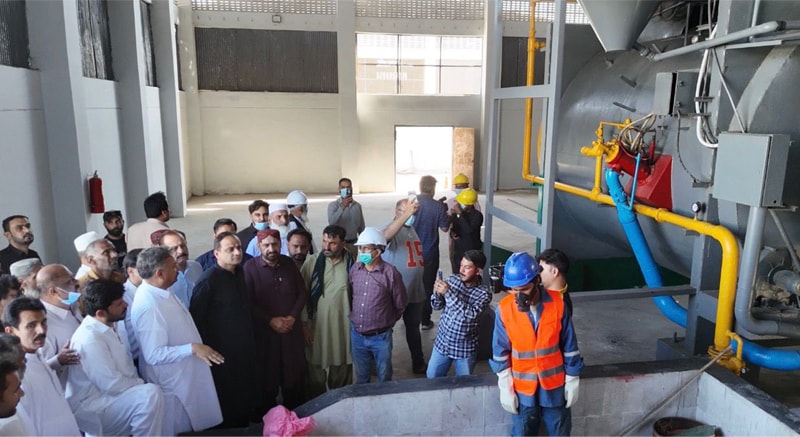 Mayor Murtaza Wahab inspects, alongside others, the newly revived incinerator.&mdash;Dawn