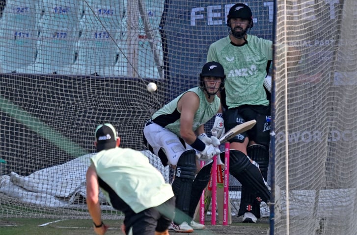 New Zealand’s Mark Chapman bats in the nets as team-mate Daryl Mitchell looks on during a training session at the Eden Gardens.—AFP