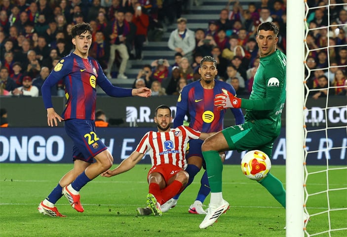 BARCELONA: Barcelona&rsquo;s Marc Bernal (L) scores past Atletico Madrid goalkeeper Juan Musso during their Copa del Rey semi-final second leg at Camp Nou.&mdash;Reuters